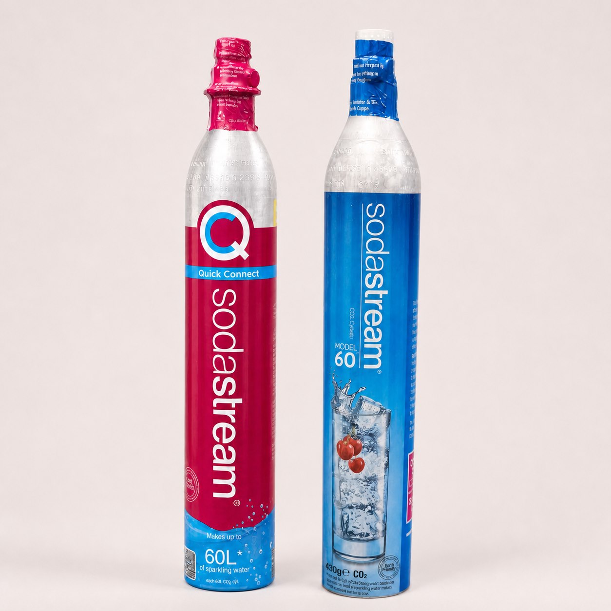 Pink Quick Connect and blue screw-in CO2 cylinders side by side for Soda ZW refill service